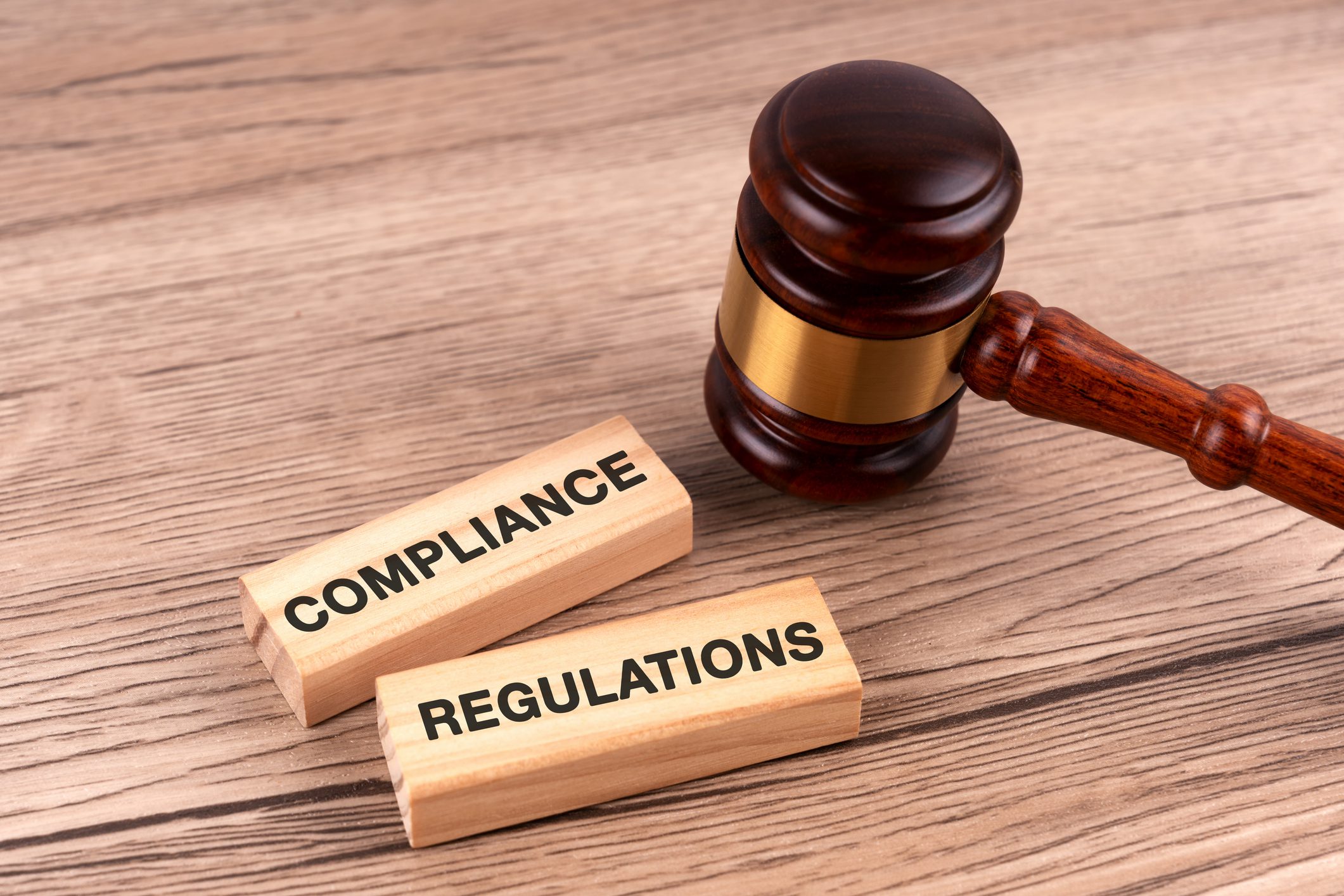 Gavel with compliance and regulations blocks